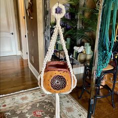 a purse hanging from a rope in front of a mirror