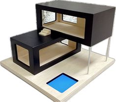 a small black and white table with a blue square in the center on top of it