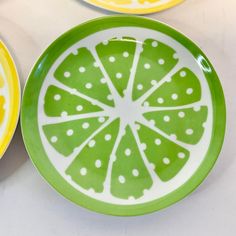 three plates with slices of lemon on them sitting on a white table top next to each other