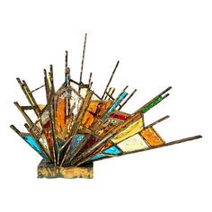 an artistic glass sculpture with sticks sticking out of it's centerpiece, against a white background