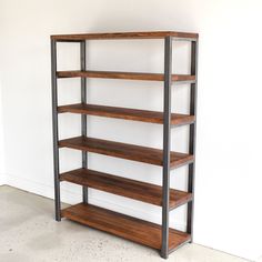 a wooden shelf with metal shelves in an empty room