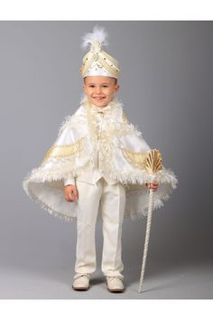 a little boy dressed up in a white and gold costume with feathers on it's cape