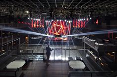 a person standing in front of a stage with lights