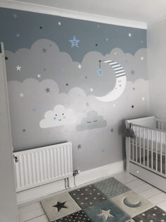 a baby's room with stars and clouds painted on the wall