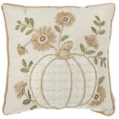 a decorative pillow with flowers and a pumpkin on the front, embroidered in gold thread