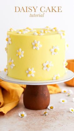 a yellow cake with white flowers on it