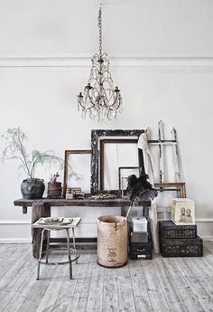 a white room with a chandelier hanging from the ceiling