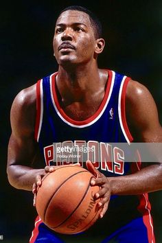 a basketball player holding a ball in his hands