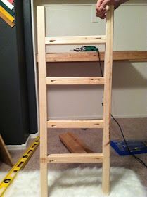 a person standing on top of a wooden ladder next to a white carpeted floor