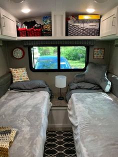 two twin beds in the back of a camper