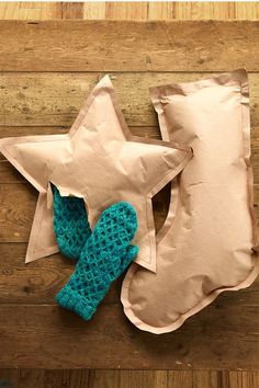 a stuffed star sitting on top of a pillow next to a pair of mittens