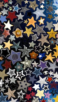 many different colored stars on a black background