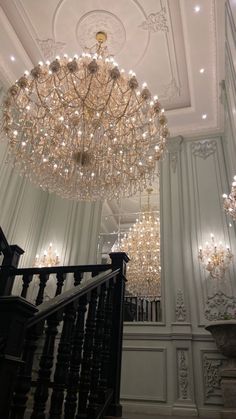 a chandelier hanging from the ceiling in a room with white walls and ceilings