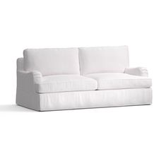 a white couch sitting on top of a white floor