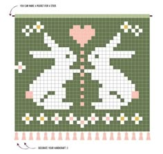 a cross stitch pattern with two white rabbits on green and pink squares in the middle