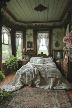 a bed sitting in a bedroom next to a window with lots of flowers on it