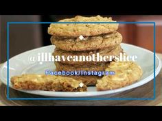 a stack of cookies sitting on top of a white plate next to a blue frame