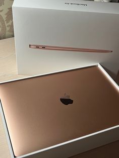 an apple laptop in its box on the table