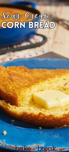 a corn bread with butter on it sitting on a blue plate