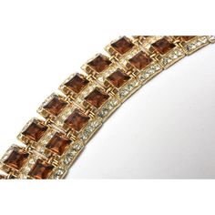 This is part of Chairish’s Costume Jewelry assortment.  This timeless vintage 1950's Swarovski rhinestone bracelet  is so well made by Henry Bogoff that it looks real. It is signed Bogoff. These amber/brown faceted cut rhinestones with clear rhinestones that look like diamonds make this a forever bracelet.  When closed it is 2.75" wide. Even the top of the safety clasp has a clear rhinestone. His pieces were elegantly crafted with quality materials often using rhodium plated settings and well ab Elegant Brown Bracelets For Party, Forever Bracelet, Amber Brown, Brown Jewelry, Rhinestone Bracelet, Clear Rhinestones, Vintage Brown, Plate Sets, Vintage 1950s