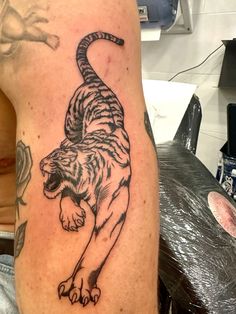 a man with a tiger tattoo on his arm