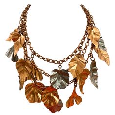 Rare and unique Gerda Lynggaard leaves necklace. What a statement jewelry. Necklace has three strands of chain and layer with bronze and silver leaf pendant. see measurement on picture attached. Leather Leaf Necklace, Leaf Clothes, Jewelry Sketching, Metro Art, Statement Jewelry Necklace, Leaves Necklace, Three Strand Necklace, Ren Fest, Jewellery Sketches