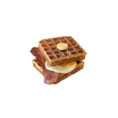 two waffles stacked on top of each other with bacon, eggs and syrup