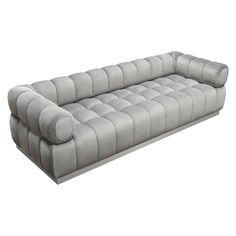 a large gray couch sitting on top of a white floor