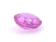 a pink diamond sitting on top of a white surface