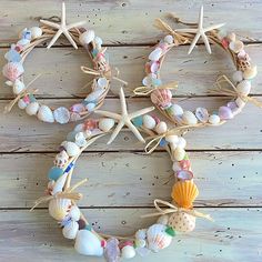 seashells and starfish are arranged in the shape of a wreath on a wooden surface