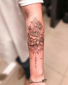 a woman's arm with a rose tattoo on it and a diamond in the middle