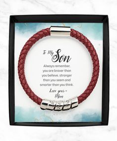 a red leather bracelet with two silver clasps and an inscription that says, to my son