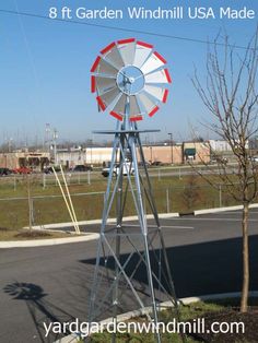 a windmill sits on the side of a road