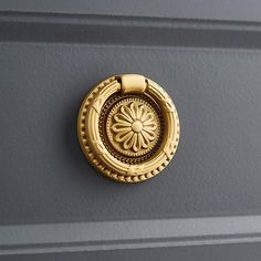 a close up of a door handle with a flower on it