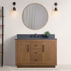 a bathroom with a sink, mirror and shelving unit on the wall next to it