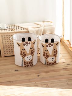 two giraffes are sitting on the floor next to each other in baskets