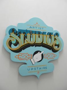 a blue sign with the word slurrios written in gold and black on it