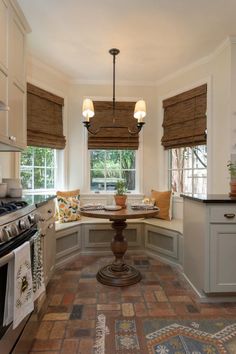 a kitchen with an oven, sink and window seat