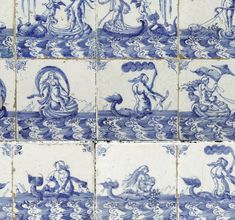 several blue and white tiles with mermaids on them