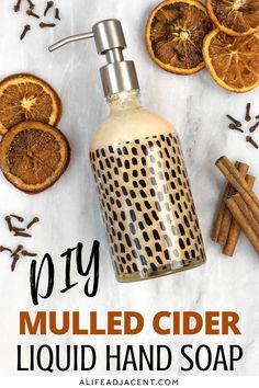 homemade diy mulled cider liquid hand soap surrounded by orange slices and cinnamon sticks