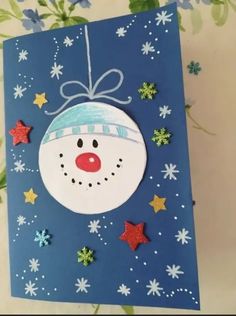 a handmade christmas card with a snowman ornament