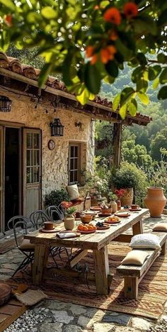 an outdoor dining area with table, chairs and potted plants on the outside patio