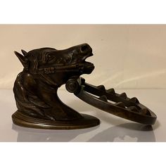 French bronze horse head door knocker with horseshoe clapper. Exceptional quality and detail with pleasing patina. The horse is fully kitted out with his bridle. Beautiful displayed on a desk or used as a wall hook. Good condition - the screws are missing. Measures 6 3/4" tall x 3 1/2" wide x 3 3/4" out from the door. Door Knocker, Door Knockers, Horse Head, The Horse, Wall Hooks, Green Eyes, Brooch Pin, Patina, Horses