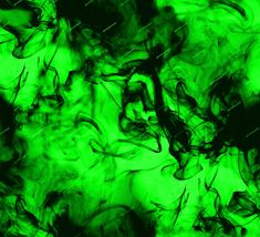 green and black ink is swirling in the air