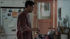 a man standing in the kitchen preparing food