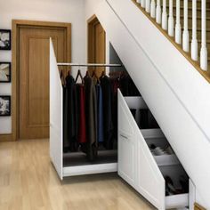 an open closet under the stairs in a house