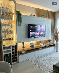 a large flat screen tv mounted to the side of a wall in a living room