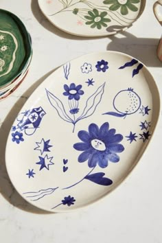 two plates with blue and white designs on them