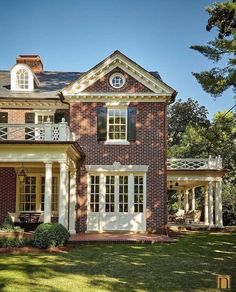 a large red brick house with white trim