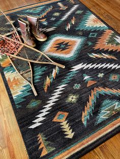 a pair of shoes sitting on top of a wooden floor next to a chair and rug